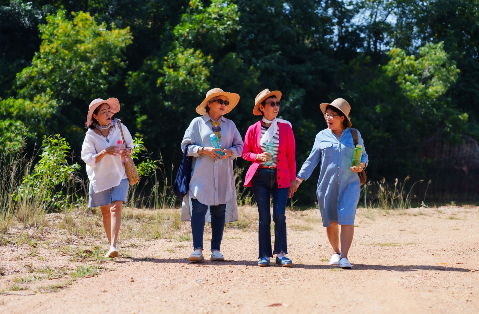 A group of independent seniors enjoys a walk together in the beautiful sunshine.